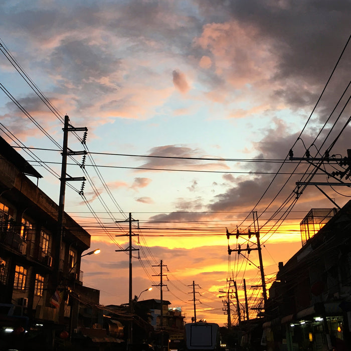 a portrait of a sunset in a village