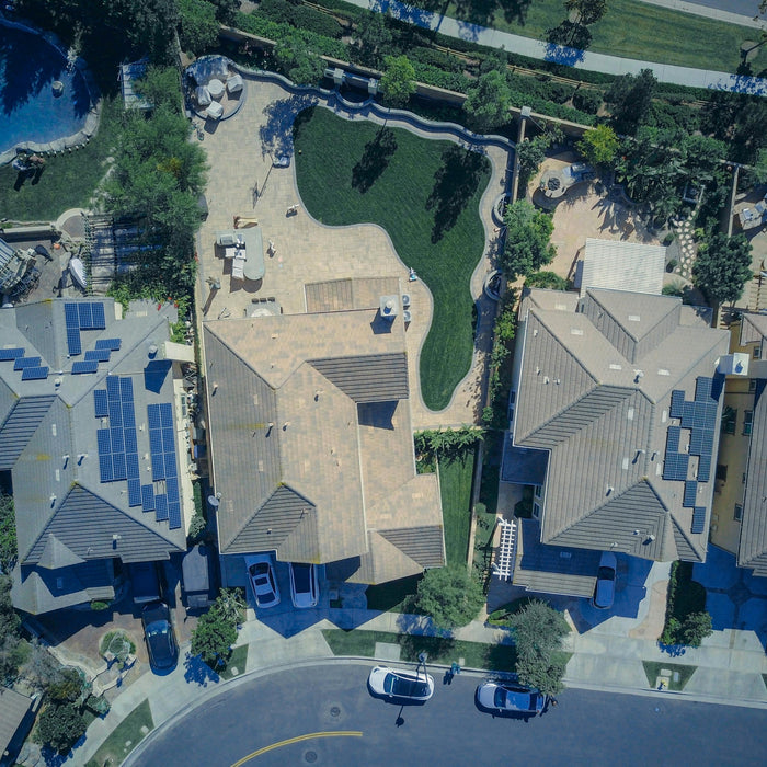 aerial shot of a solar panels installed in the roof of the house