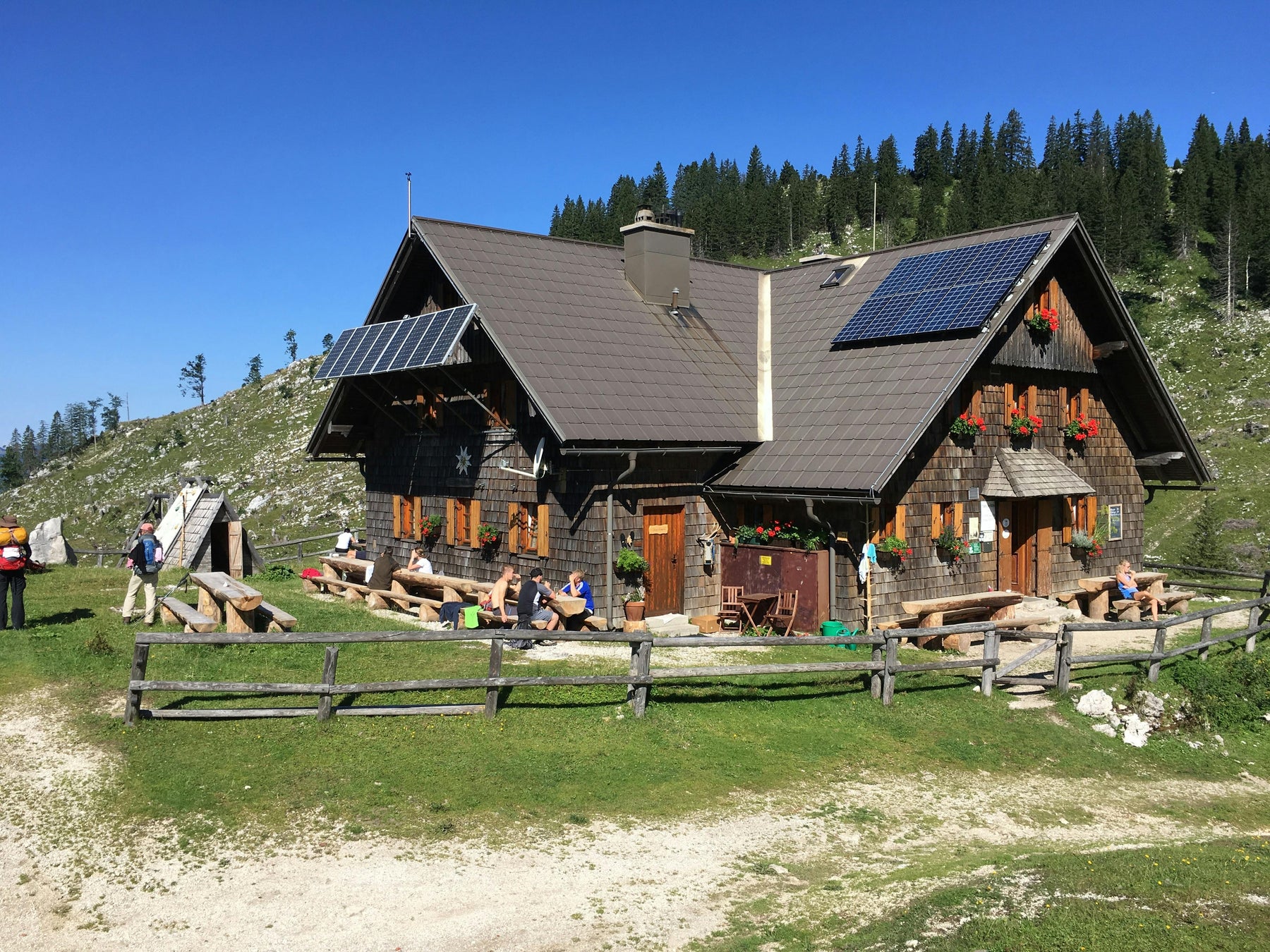 a solar panels installed in a nice house with the background of trees
