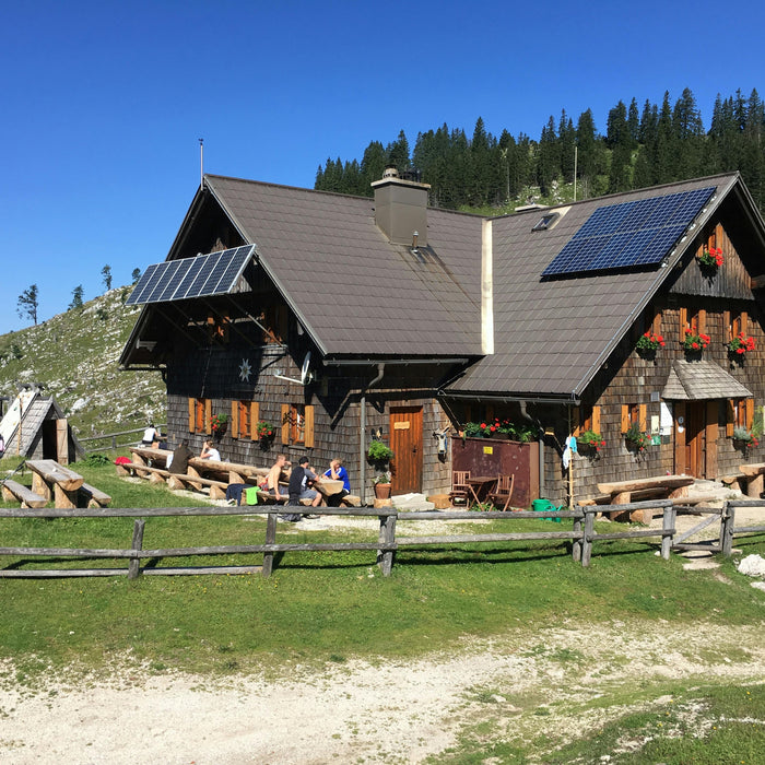 a solar panels installed in a nice house with the background of trees