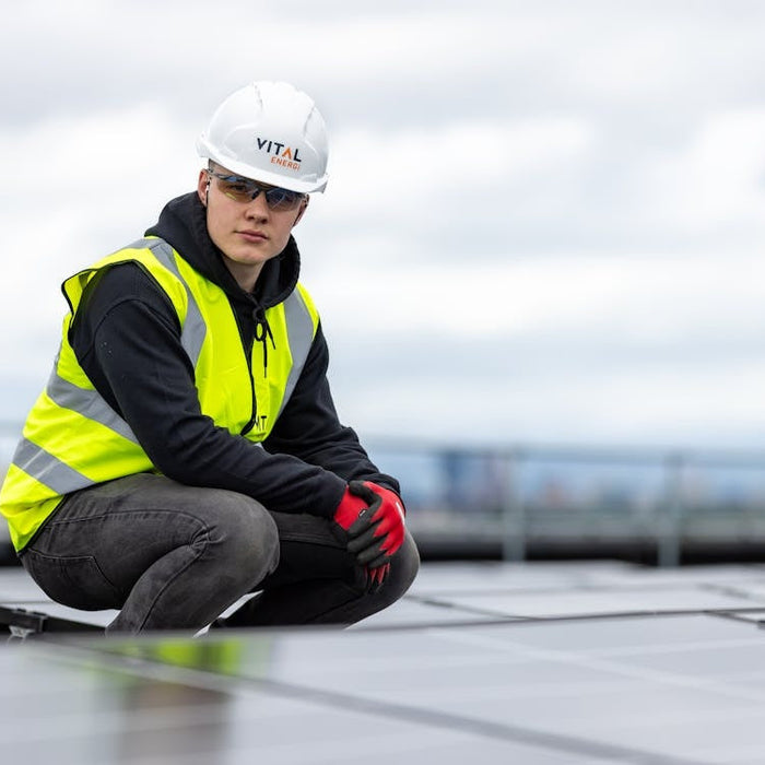a person sitting in the field of solar panels